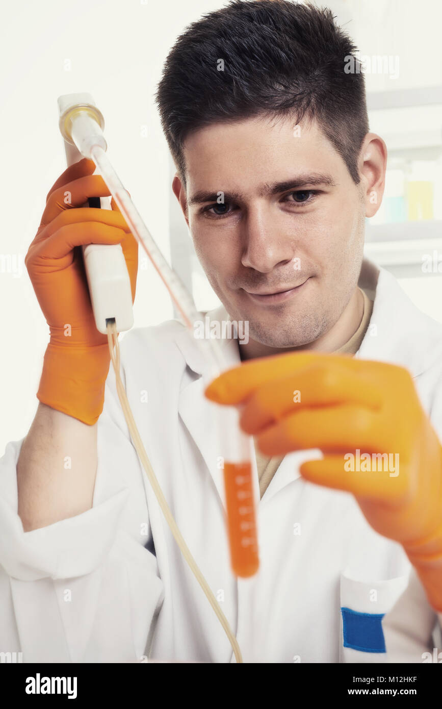 Young microbiologist works with bacterial cultures in the lab, toned