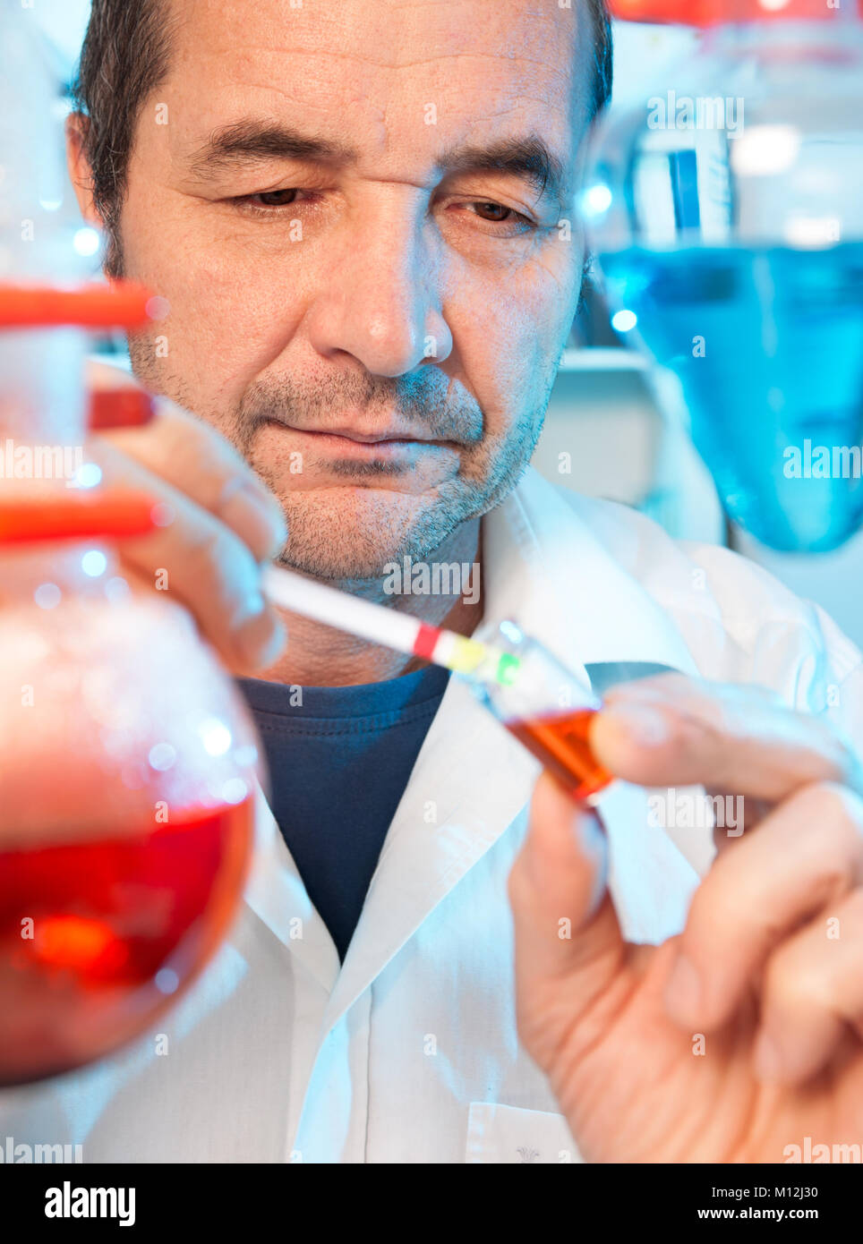 Senior scientist works in chemical laboratory Stock Photo