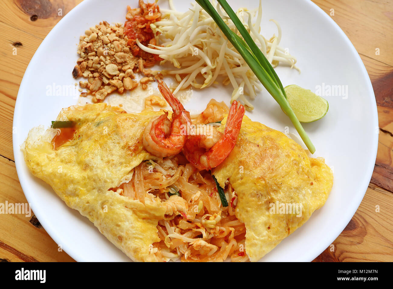 Thai Style Fried Egg Wrapped Stir Fried Noodle or Pad Thai Topped with