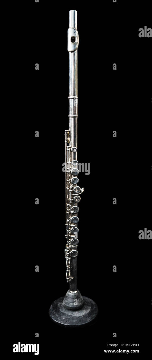 Full view of a transverse flute standing isolated in black Stock Photo