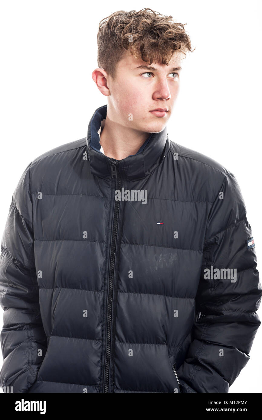 A 14 year old boy wearing a coat in the studio Stock Photo