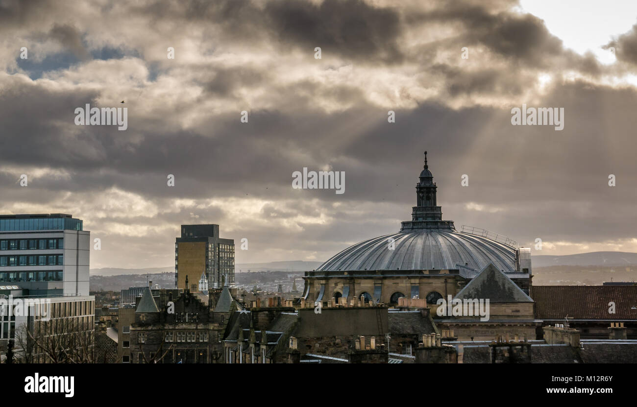 Rooftop of McEwan Hall, University of Edinburgh graduation hall, and Appleton Tower, with moody dark sky and light stream, Edinburgh, Scotland, UK Stock Photo