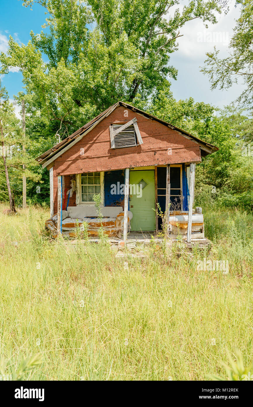 Old abandoned, vacant house with falling down or dilapidated front porch in rural Alabama, United States. Stock Photo