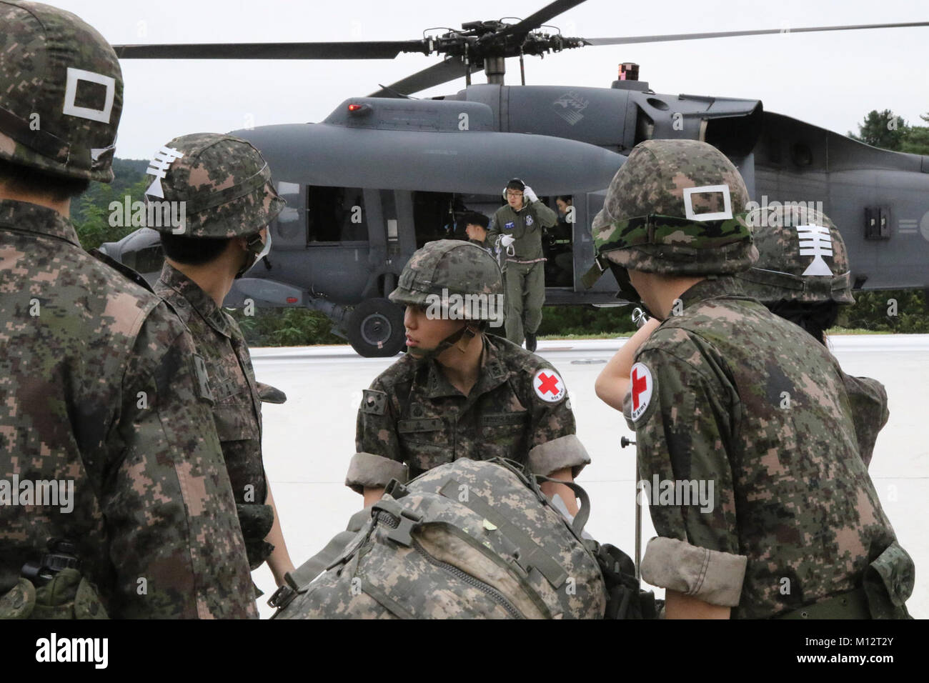 Republic of Korea Army medics transport a US Soldier casualty to a ROK helicopter that then transported the casualty to a ROK landing ship tank Aug. 30 at Hongcheon, during a simulated mass casualty training excercise called “Dragon Lift.” Stock Photo