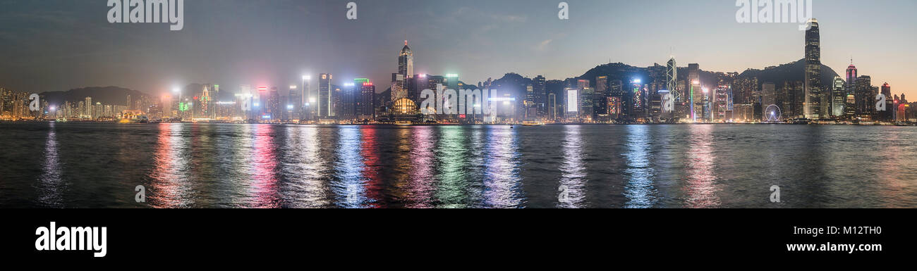 Panoramic view of Hong Kong skyline and its reflection at sunset Stock ...