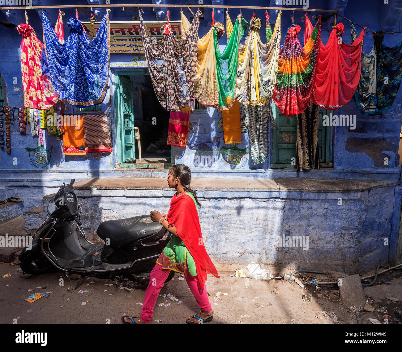 Woman walking in the street in blue city of India Jodhpur Stock Photo ...