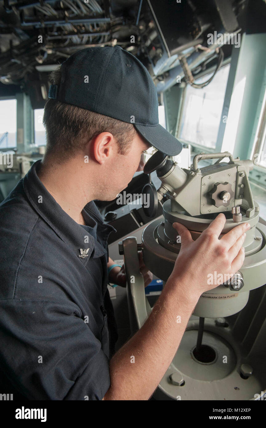 PACIFIC OCEAN (Jan. 21, 2018) Boatswain’s Mate 3rd Class Daniel Lynch, a Detroit native, reads the ship’s bearing using a telescopic alidade on the bridge aboard the amphibious assault ship USS America (LHA 6) America, part of the America Amphibious Ready Group, with embarked 15th Marine Expeditionary Unit, is returning from a 7-month deployment to the U.S. 3rd, 5th and 7th fleet areas of operations. (U.S. Navy Stock Photo