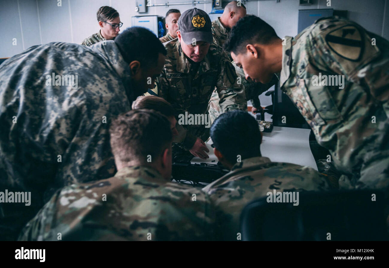 CAMP CASEY, REPUBLIC OF KOREA- Sgt. 1st Class Allen Parsons instructs hopeful Master Gunner School candidates in the assembly and disassembly of the M240 machine gun during the 2nd Armored Brigade Combat Team’s Sabot Academy. Stock Photo