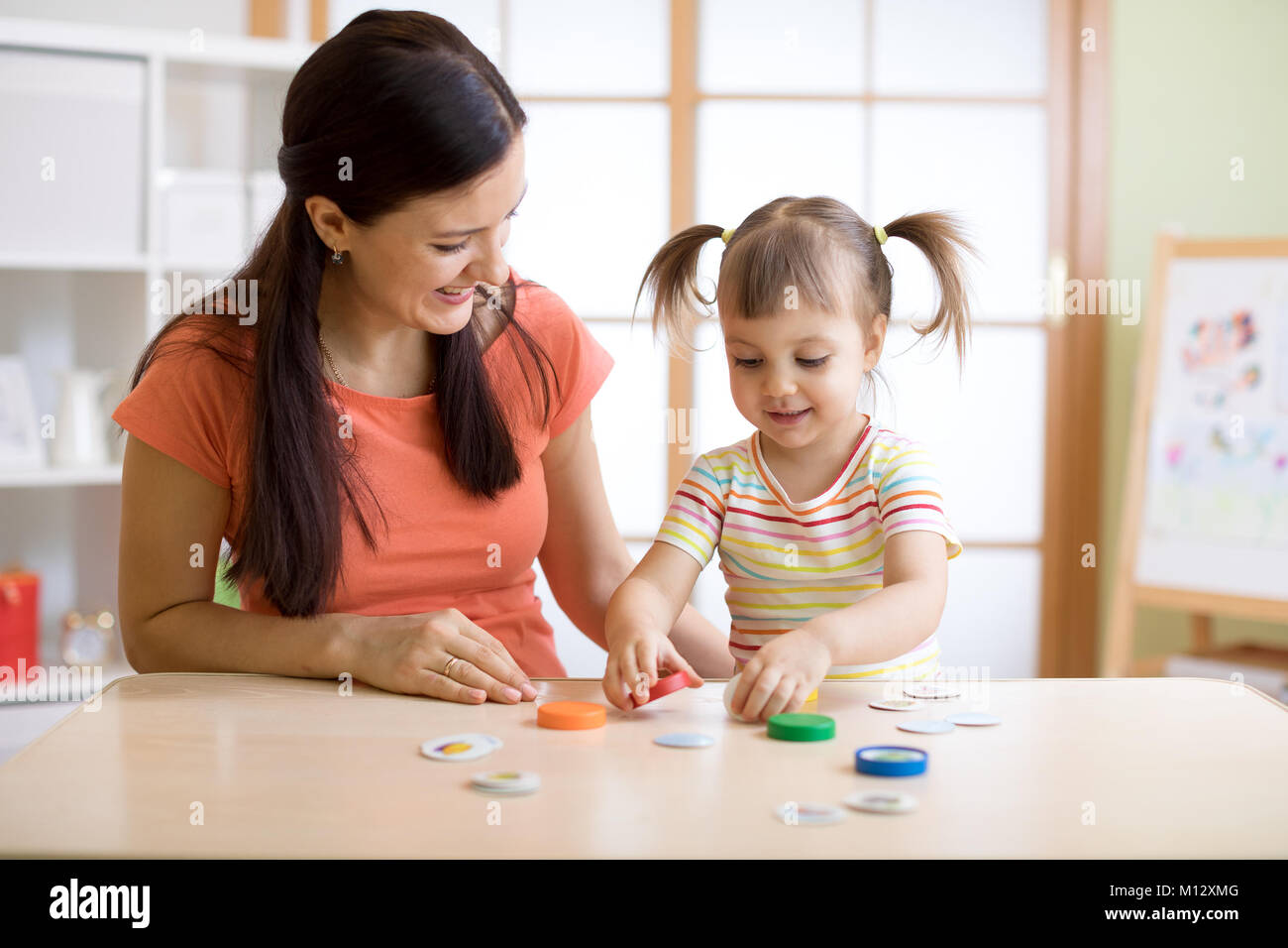 Mom with creative child having fun time together Stock Photo
