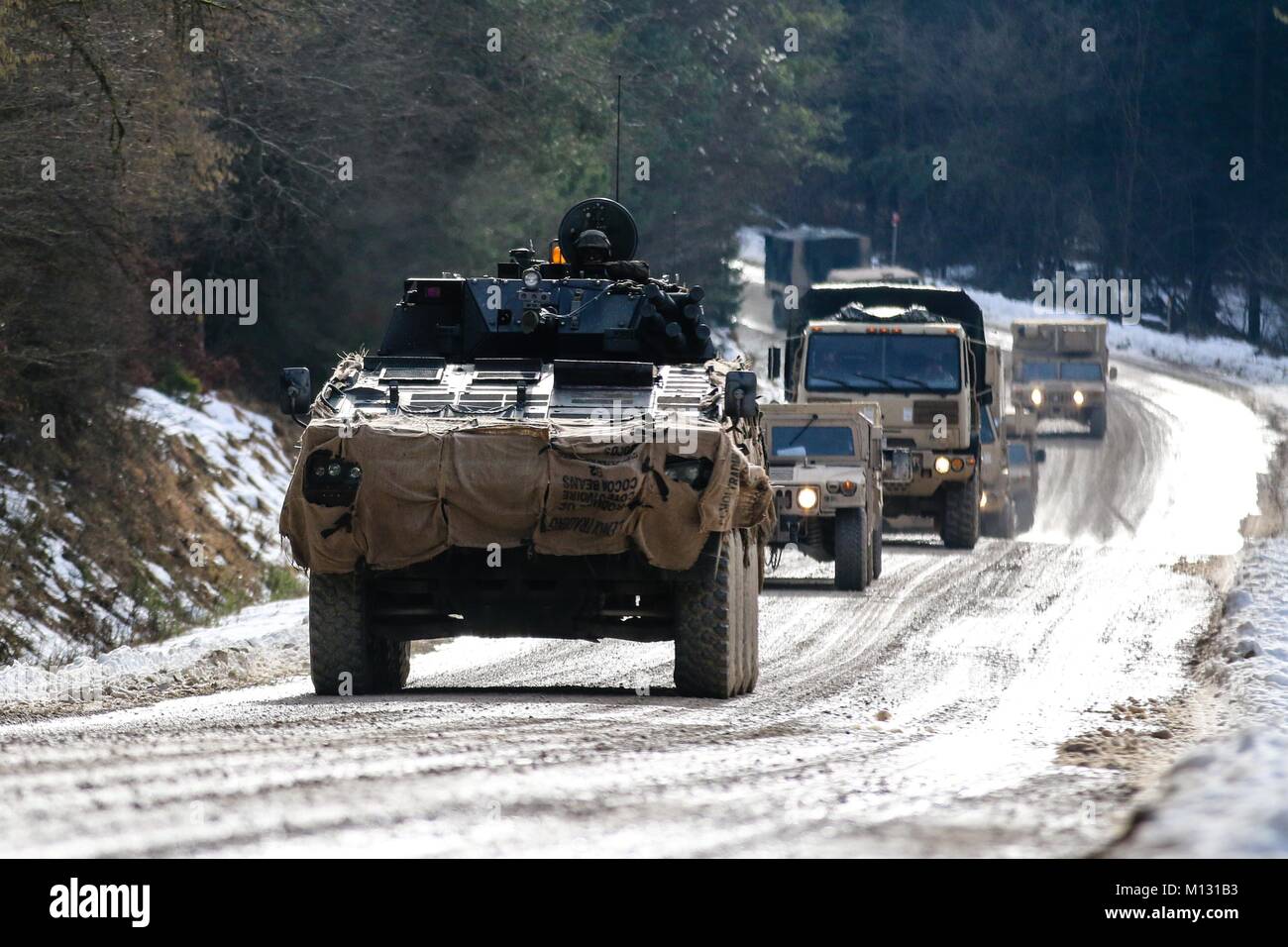 A Polish army Rosomak armored personnel carrier, also called a Wolverine, assigned to the 12th Mechanized Brigade, leads a convoy of Polish and U.S. military vehicles during the Allied Spirit VIII training exercise at Hohenfels Training Area, Germany, Jan. 25, 2018. Allied Spirit VIII is a multinational exercise with over 4,100 participants from 10 nations that is designed enhance interoperability among participating nations and readiness across the U.S. military's war-fighting functions. (U.S. Army photo by Spc. Hubert D. Delany III / 22nd Mobile Public Affairs Detachment)  Stock Photo