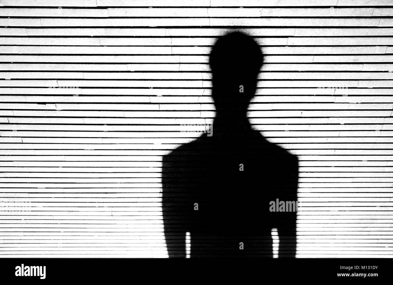 Anonymous person portrait silhouette in black and white on patterned background Stock Photo