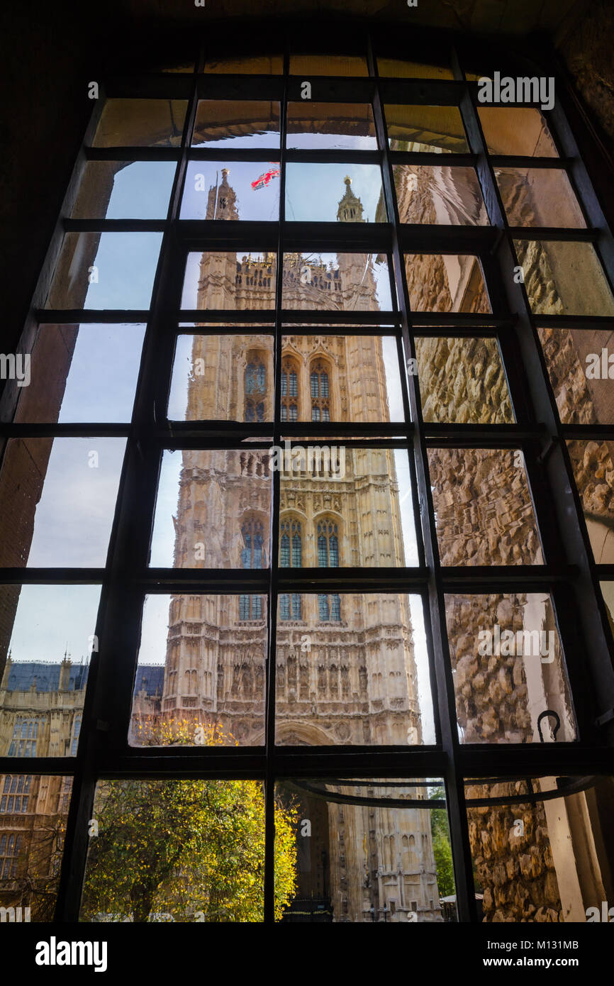 The Victoria Tower at the south-west end of the Palace of Westminster as viewed through medieval window of Jewel Tower, City of Westminster, Central A Stock Photo