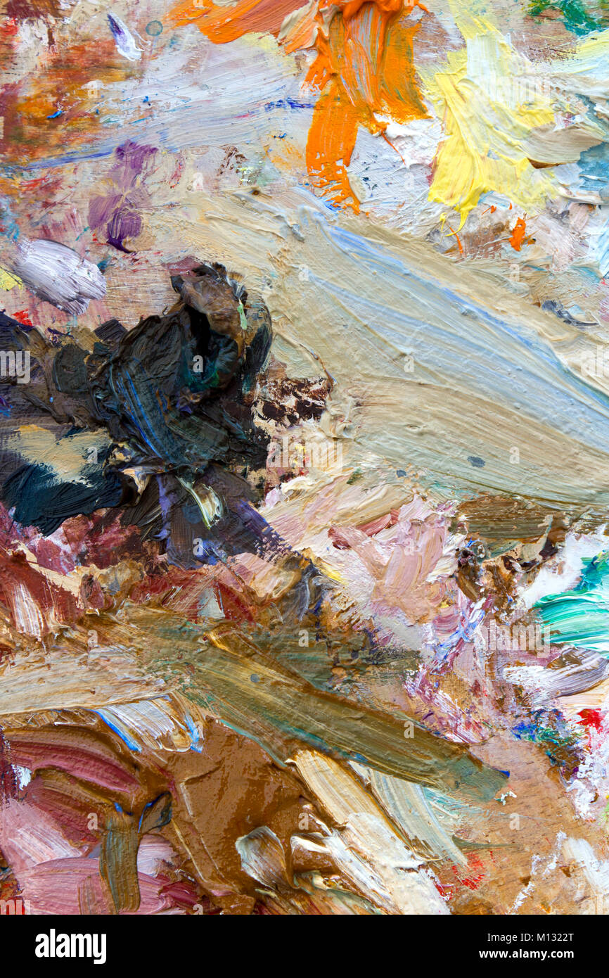 Vibrant multi-coloured artists oil paint palette. Shallow depth of