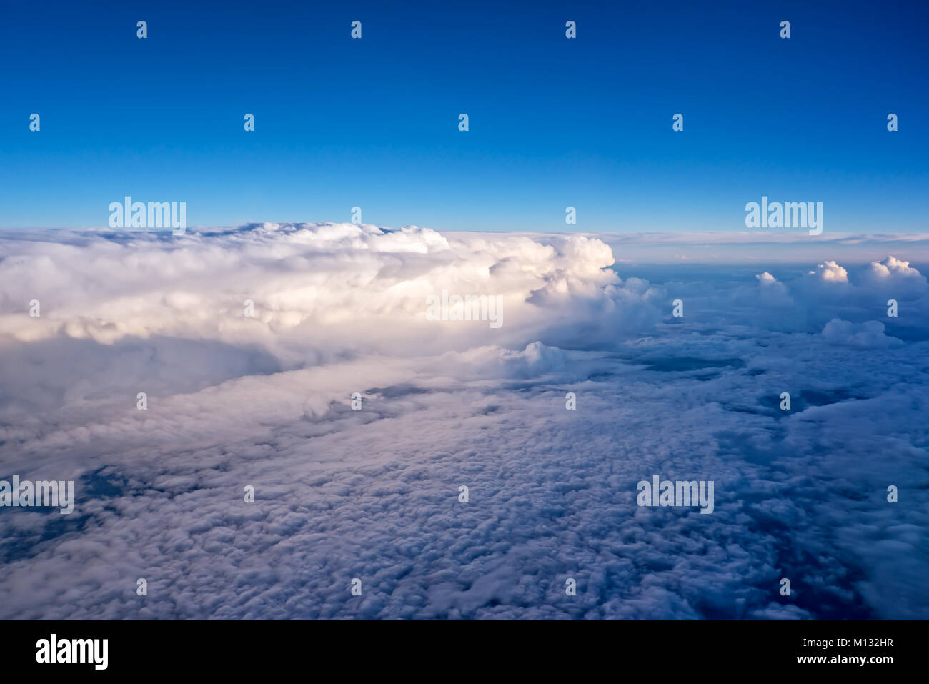 View of the sky and clouds from the airplane porthole Stock Photo