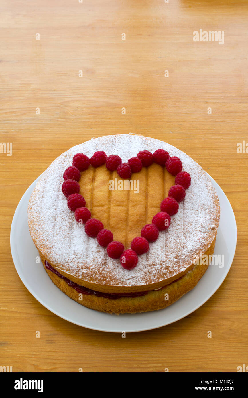 Sponge cake decorated with a heart shape picked out in fresh ...
