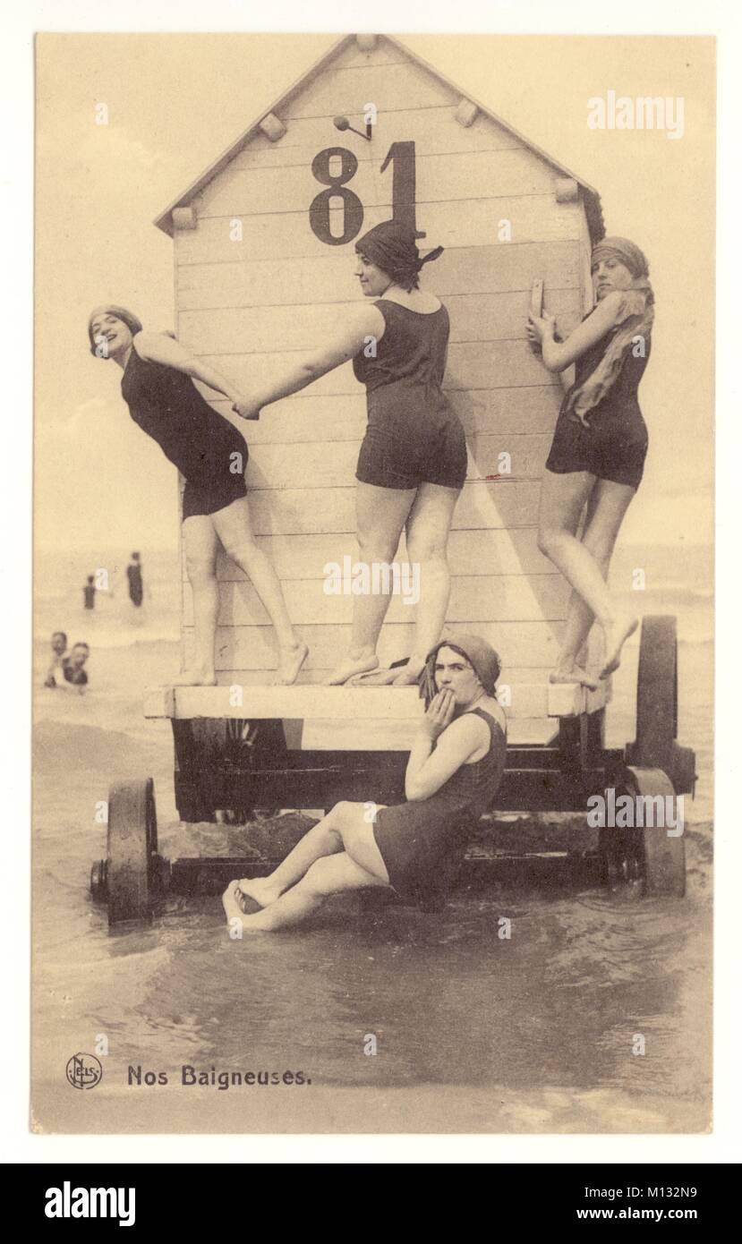 Edwardian postcard entitled "Nos Baigneuses" - a group of ladies in bathing costumes pose on a traditional bathing hut, from Ostende, Belgium, circa 1907  Retro beach photo Stock Photo
