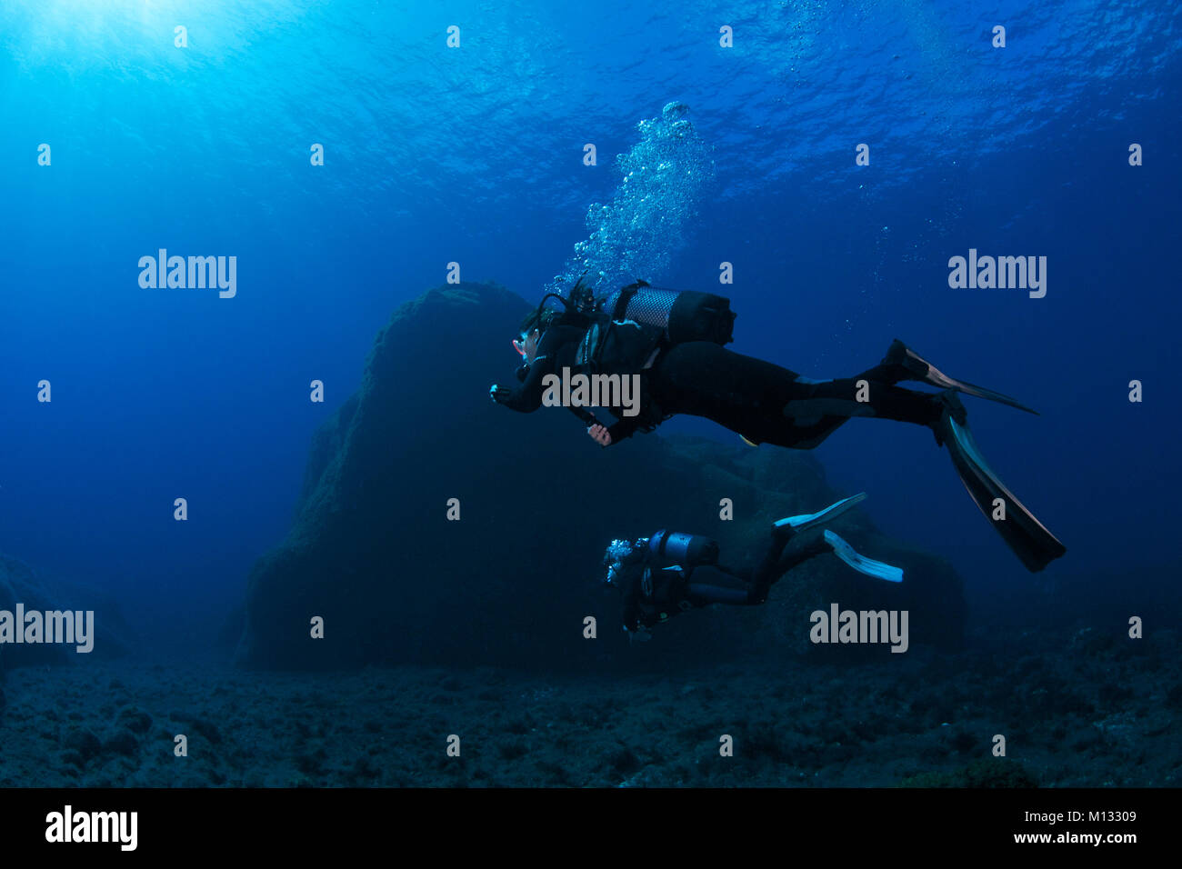 Scuba divers at Cueva del Diablo dive site in Mar de las Calmas Marine Reserve (El Hierro, Canary Islands, Spain) Stock Photo