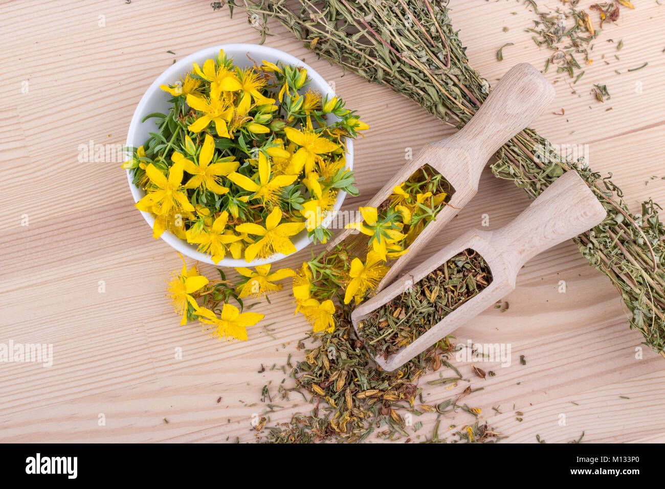 top view on dried and fresh, flowering St. John's wort on a wooden background Stock Photo