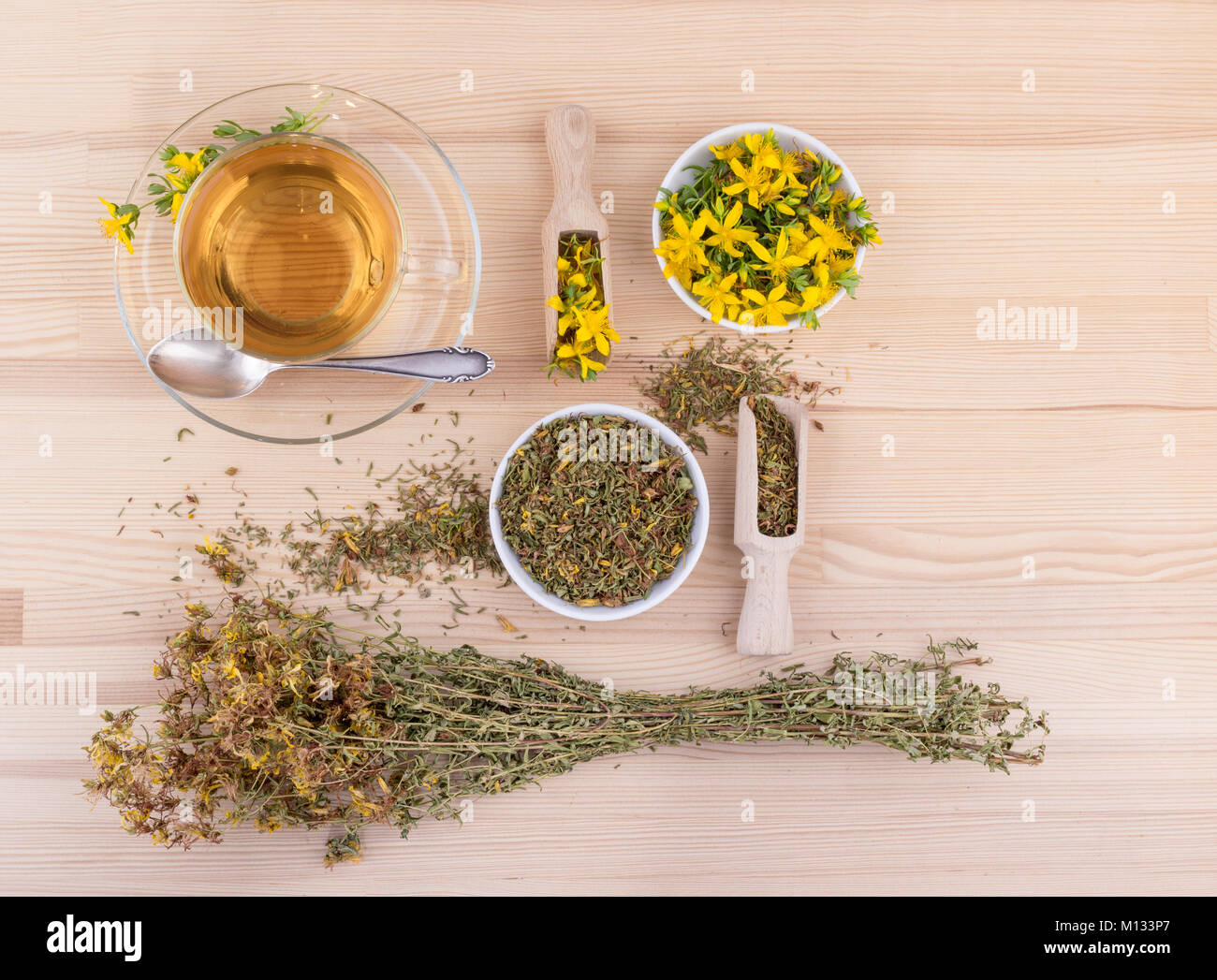 Cup of herbal tea with dried and fresh St. John's wort  on a wooden background Stock Photo