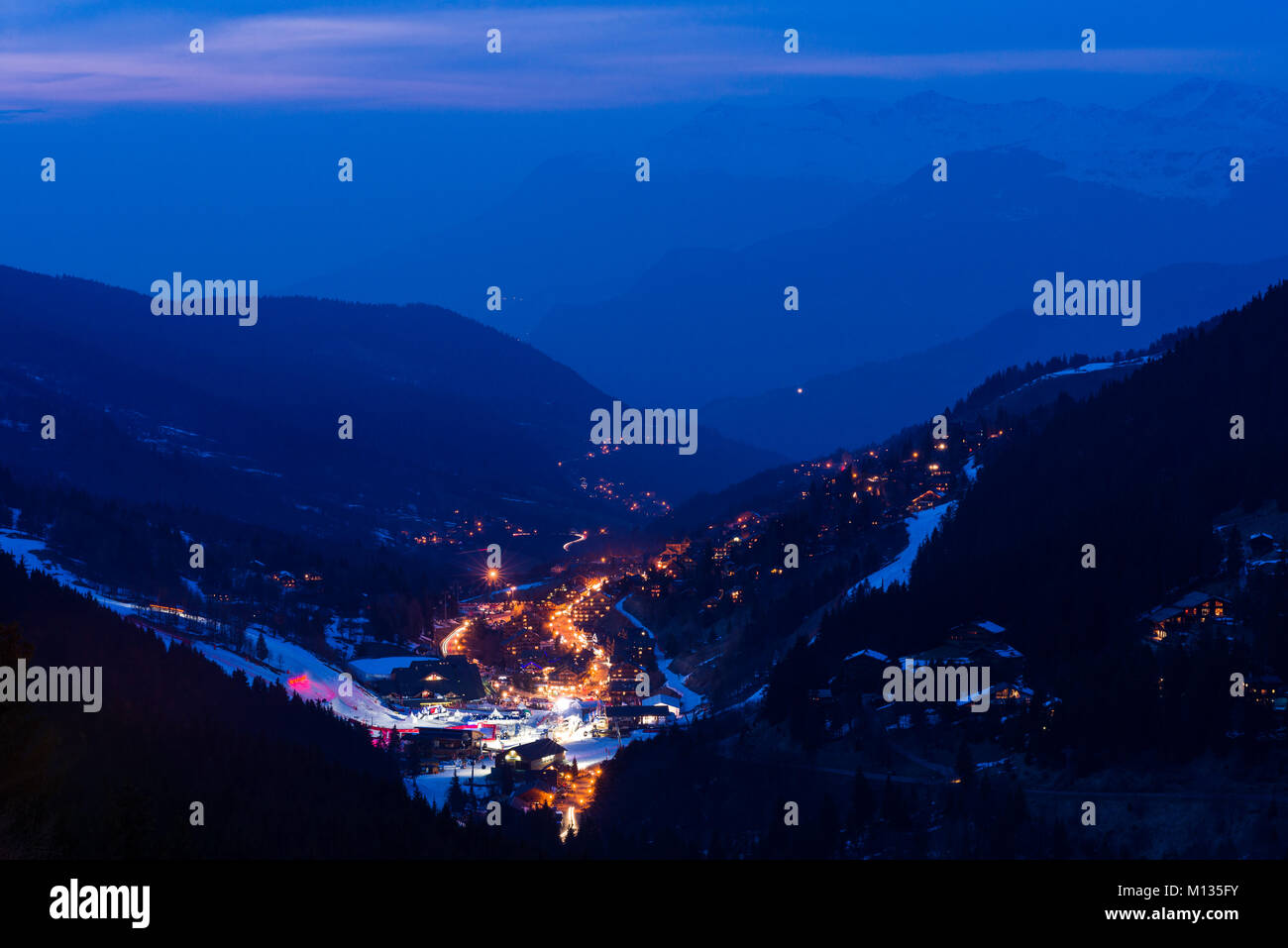 The ski resort town of Meribel and the 3 Valleys mountain area at dusk, France Stock Photo