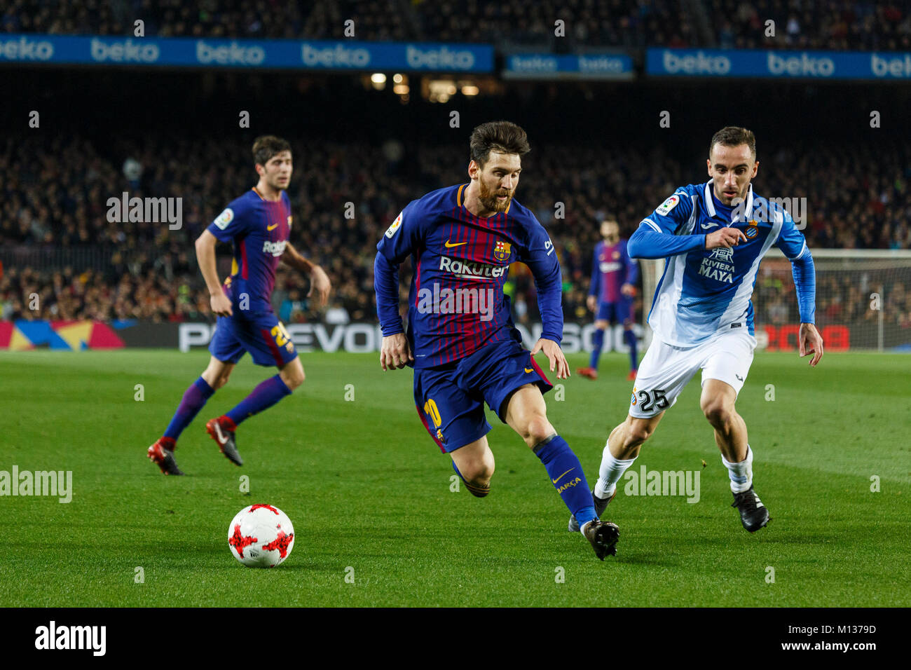 Barcelona, Spain. 25th Jan, 2018. FC Barcelona's Lionel Messi(front L) and RCD Espanyol's Sergio Darder vie for the ball during the Spanish King's Cup match between FC Barcelona and RCD Espanyol in Barcelona, Spain, on Jan. 25, 2018. FC Barcelona won 2-0. FC Barcelona is qualified for semifinals. Credit: Joan Gosa/Xinhua/Alamy Live News Stock Photo