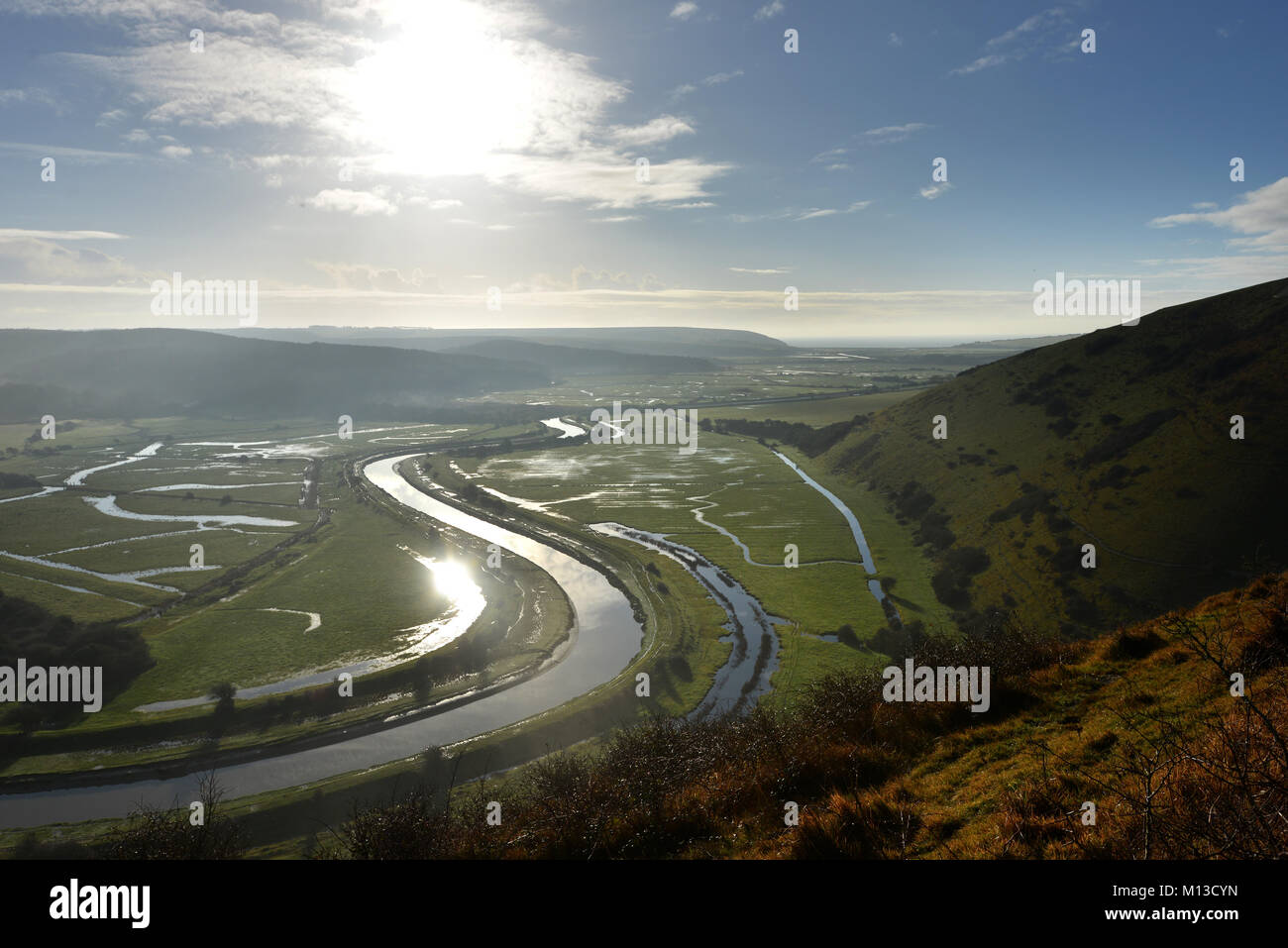 Seaford, UK. 26th January 2018. The sun shining on the river Cuckmere as it meanders through the South Downs National park near Seaford. Credit: Peter Cripps/Alamy Live News Stock Photo