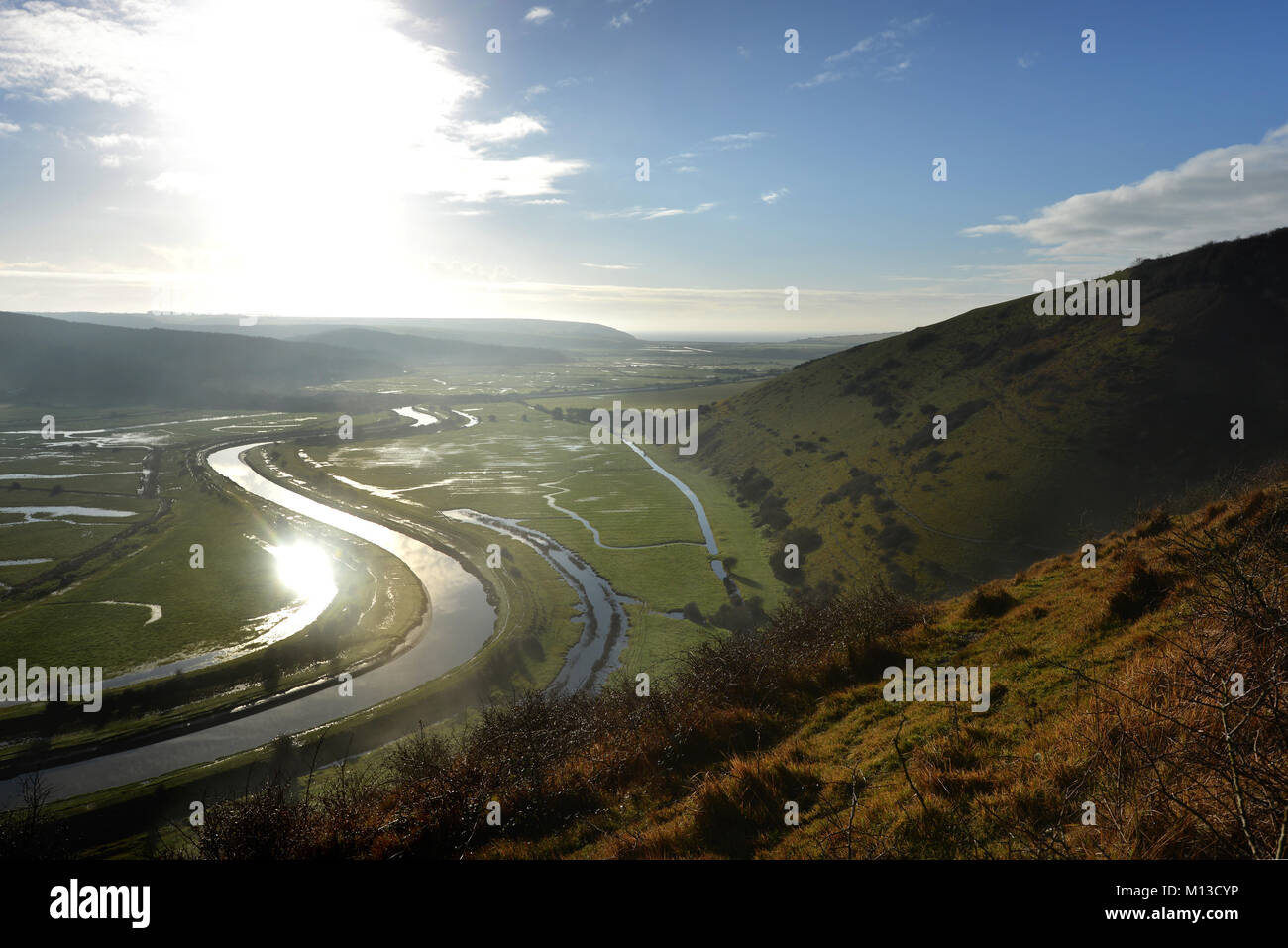 Seaford, UK. 26th January 2018. The sun shining on the river Cuckmere as it meanders through the South Downs National park near Seaford. Credit: Peter Cripps/Alamy Live News Stock Photo
