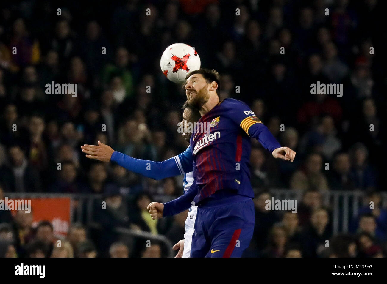 Camp Nou, Barcelona, Spain. 25th January, 2018. Lionel Messi fighting an aerial ball with Javi Fuego during the quarter finals of Copa de S.M. del Rey 17/18 on the match between Fc Barcelona and Rcd Espanyol at Camp Nou, Barcelona, Spain. Credit: G. Loinaz/Alamy Live News Stock Photo
