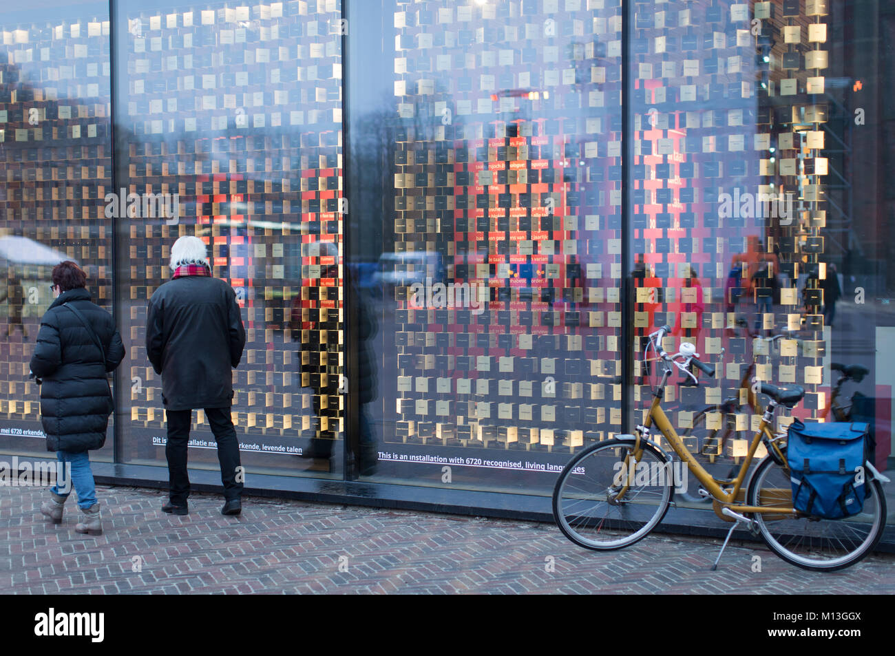 Leeuwarden, Netherlands. 26th Jan, 2018. Passerbys standing in front of an installation, which visualizes 6720 living languages in Leeuwarden, Netherlands, 26 January 2018. Leeuwarden in the Frisian province is the Capital of Culture 2018. Credit: Friso Gentsch/dpa/Alamy Live News Stock Photo