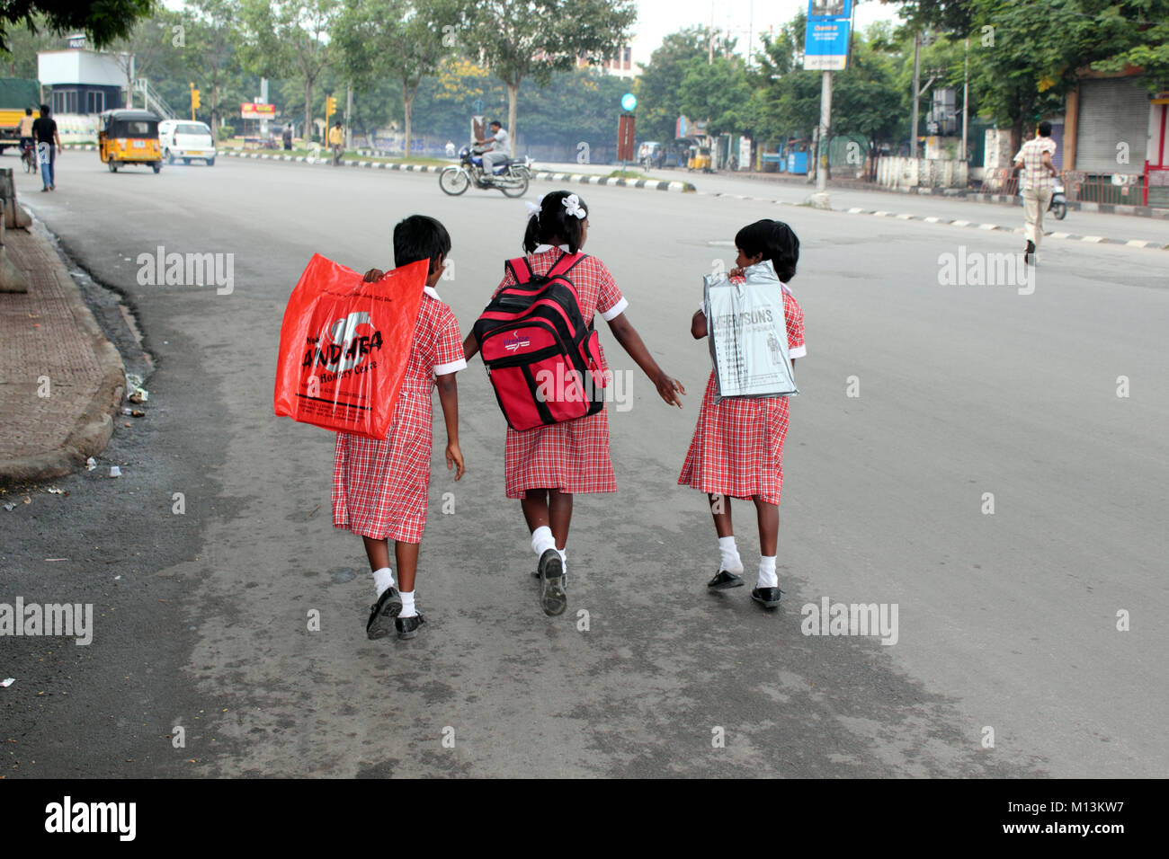 Indian schoolgirls going along busy street to school Stock Photo Alamy