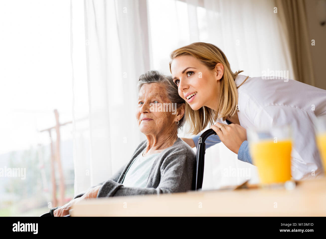 Health visitor and a senior woman during home visit Stock Photo Alamy