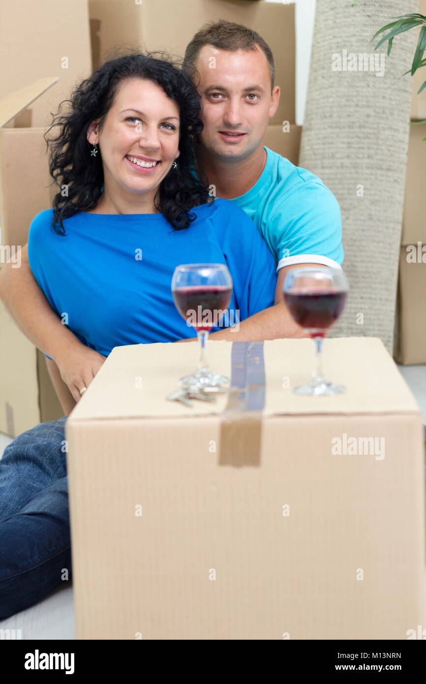 couple in their new home with cardboard boxes around Stock Photo - Alamy