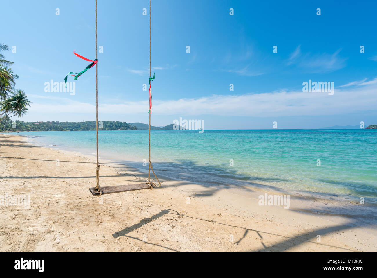 Swing hang from coconut palm tree over summer beach sea in Phuket ,Thailand. Summer, Travel, Vacation and Holiday concept Stock Photo