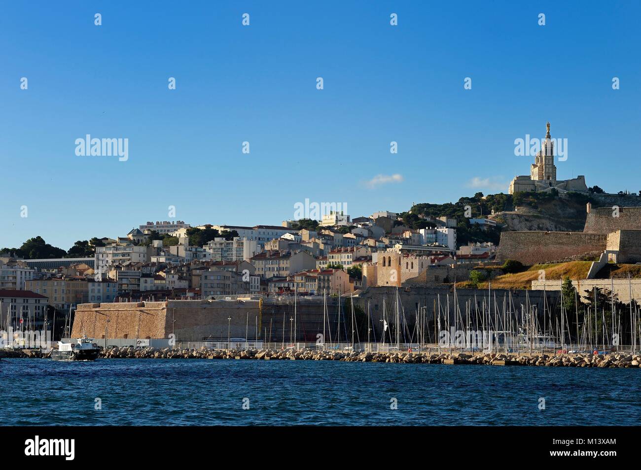 France, Bouches du Rhone, Marseille, the Vieux Port, the Fort Saint Nicolas, the Saint Victor abbey and Notre Dame de la Garde in the background Stock Photo