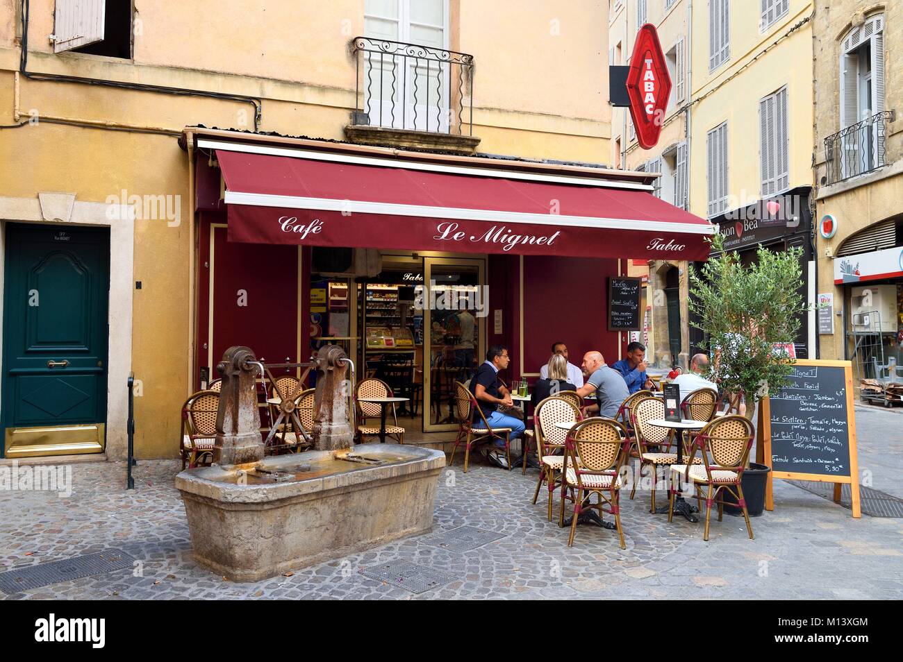 France, Bouches du Rhone, Aix en Provence, Café-Tabac Le Mignet and fountain Stock Photo