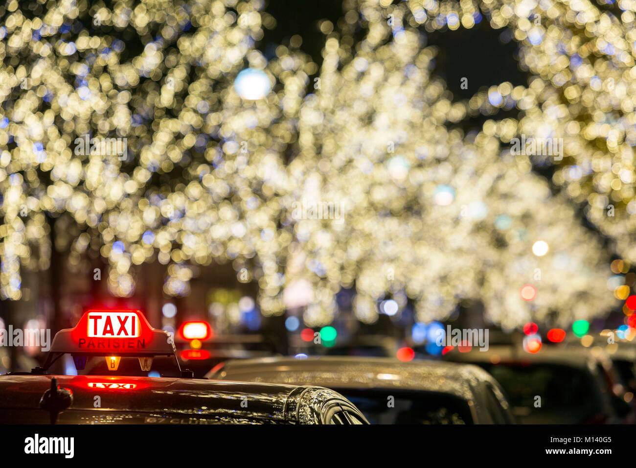 France, Paris, Taxi line Avenue Montaigne and Christmas lights Stock Photo