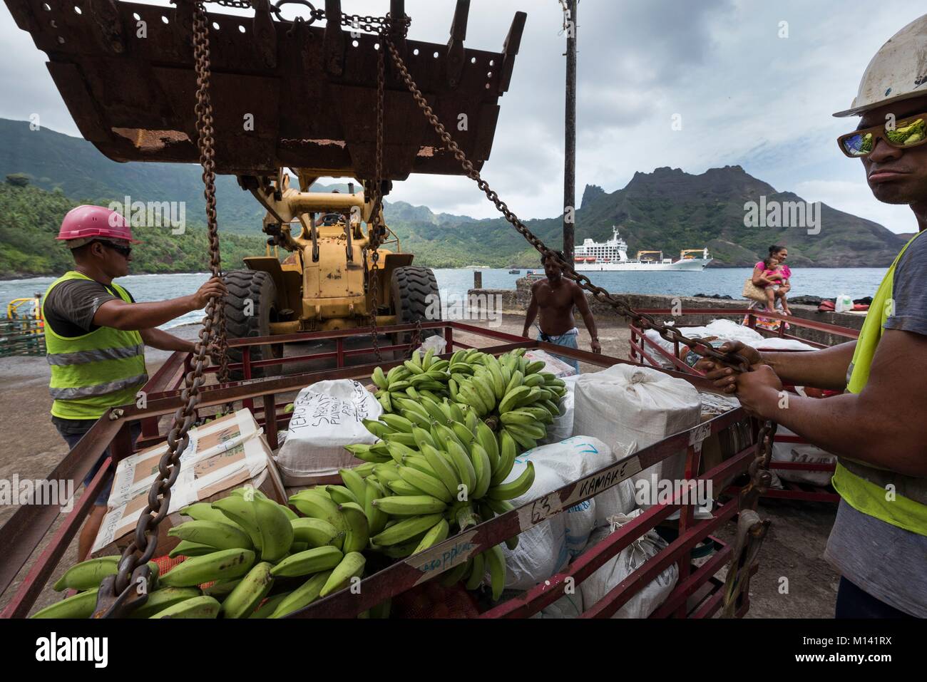 France, French Polynesia, Marquesas Archipelago, Hiva Oa Island, Puamau, cruise aboard the Aranui 5, Aranui 5 at anchor in the bay, boarding of goods Stock Photo