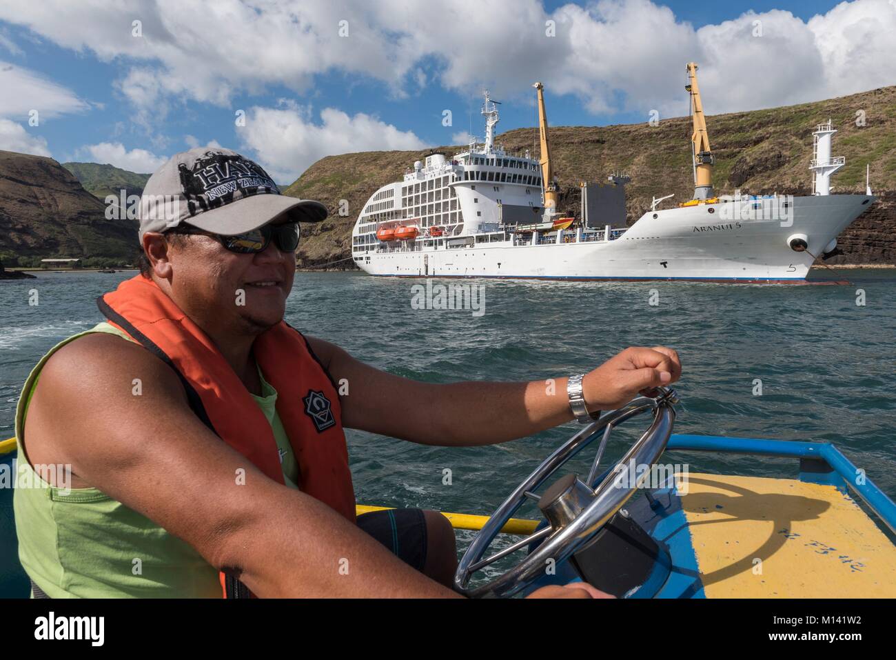 France, French Polynesia, Marquesas Archipelago, Ua Huka Island, Vaipaee Bay, cruise aboard Aranui 5, Aranui 5 at anchor in the bay, Francis Chougue piloting a barge Stock Photo