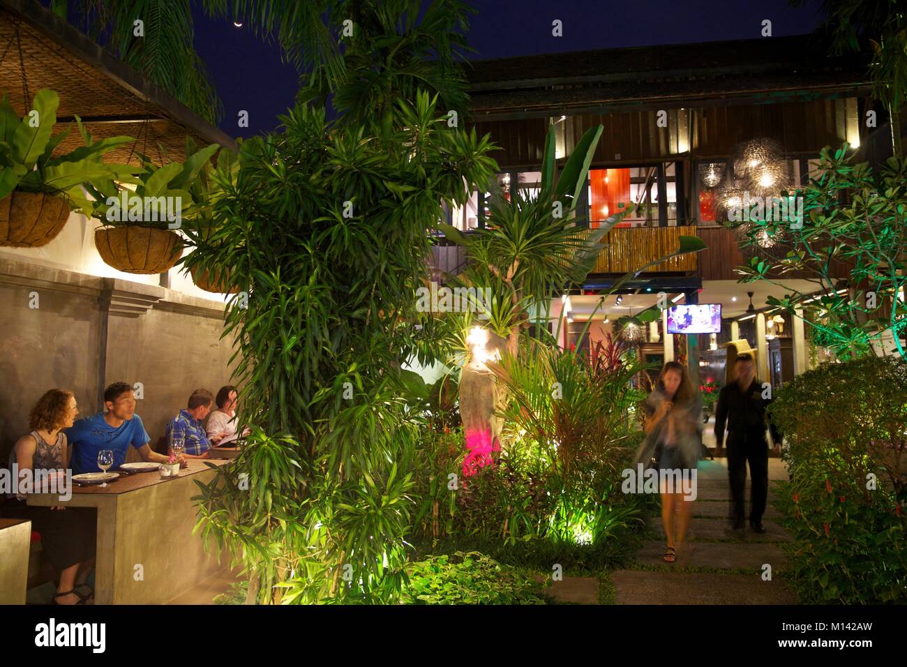 Cambodia, Siem Reap, guests in the garden of the khmer cuisine restaurant Chanrey tree lit at night Stock Photo