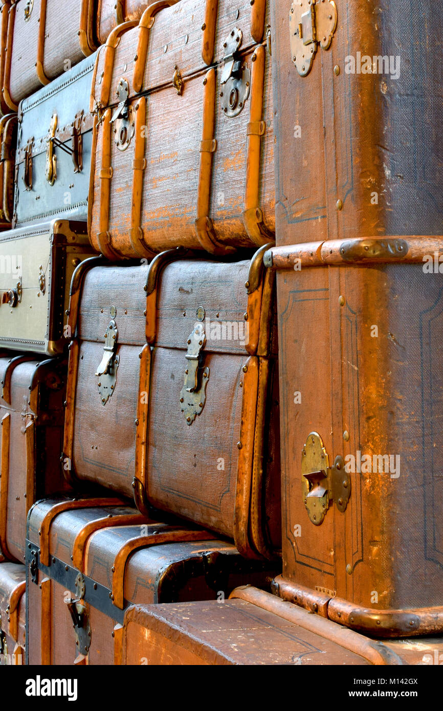 Pile of old vintage suitcases. Vertical image. Stock Photo