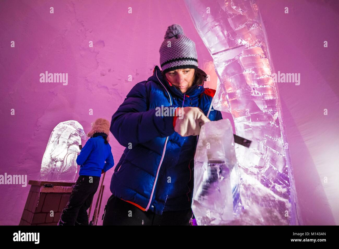 France, Savoie, Tarentaise valley, Vanoise massif, Arcs 2000 ski resort, Manon CHERPE sculpts an ice fish with the chainsaw, for the sculpture gallery of the village-igloo, during the winter season 2017-2018 Stock Photo
