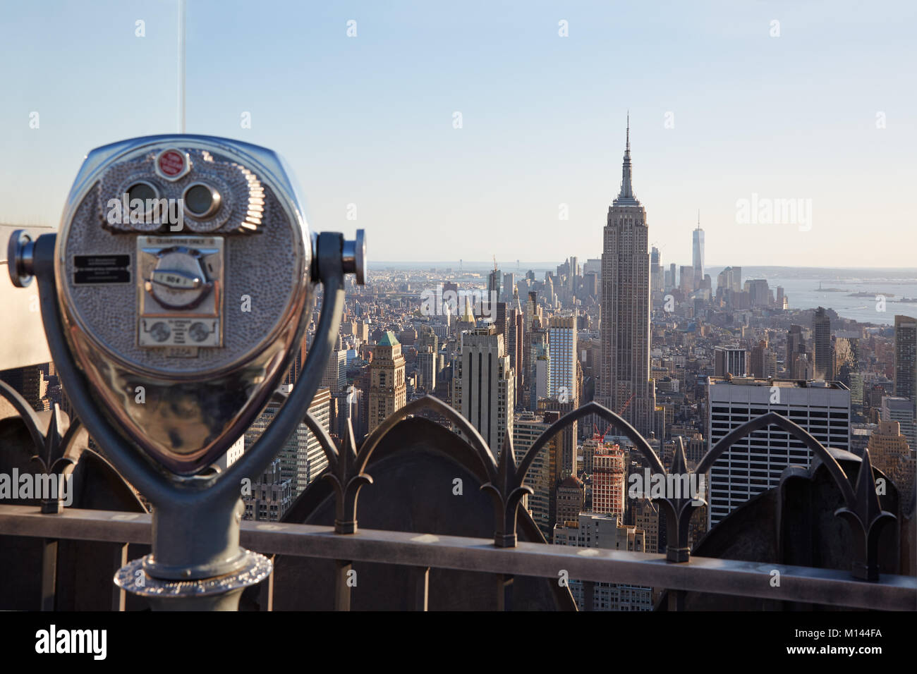 Binoculars on Rockefeller Center with Empire State Building and city