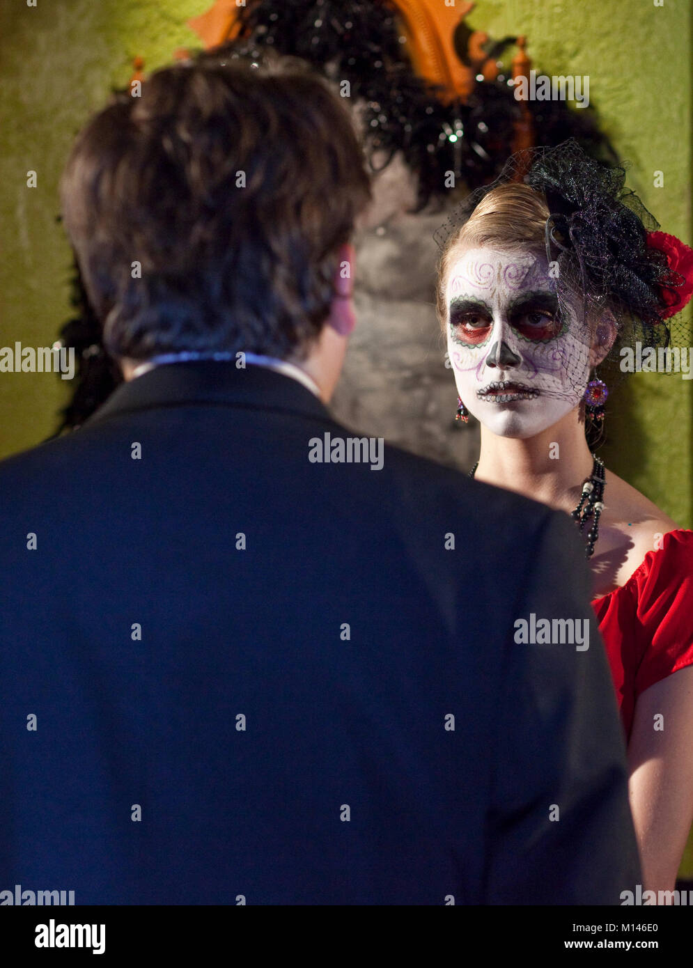 A man and woman dressed in traditional Day of the Dead makeup. Stock Photo