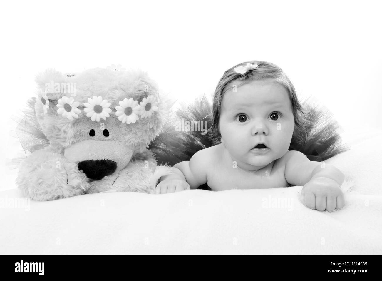 3 month old girl in nursery with teddy, pretty little girl Stock Photo