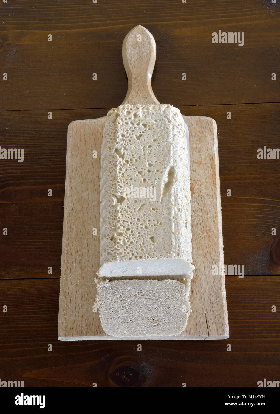 Halva of vanilla flavor on wooden board and knife Stock Photo Alamy