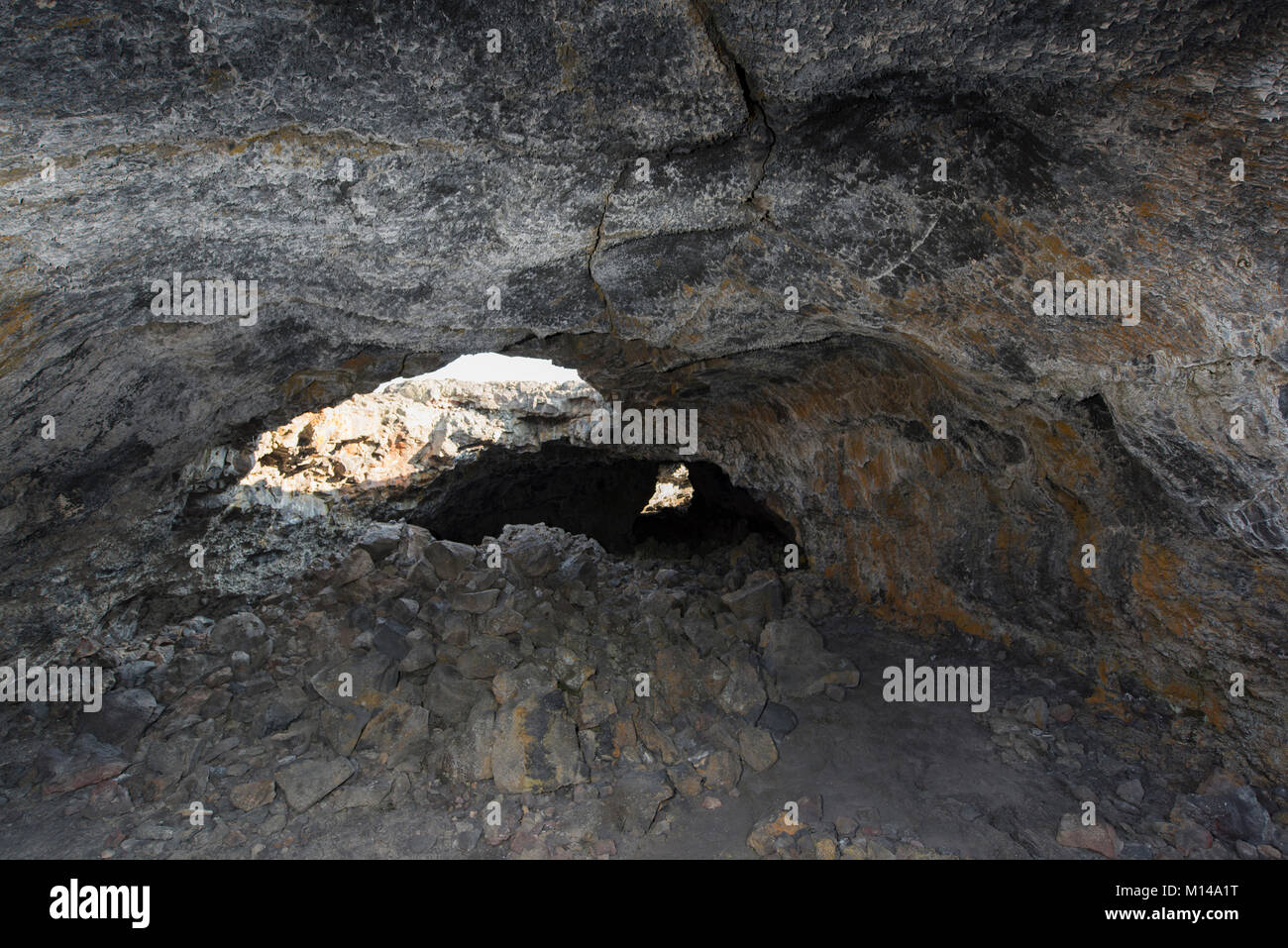 Inside the Indian Tunnel, a partially collapsed lava tube at Craters of the Moon Natl. Monument, Idaho, USA. Stock Photo