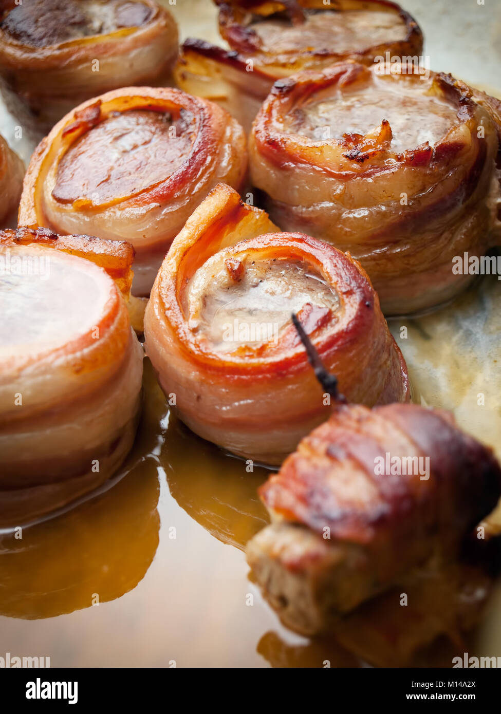Delicious pork steaks wrapped with tasty bacon. Stock Photo