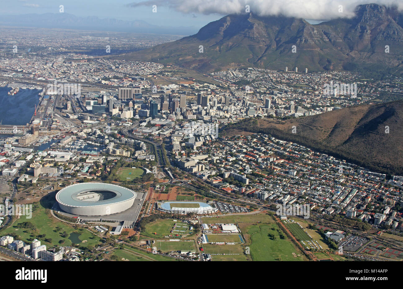 Helicopter view of Midtown Cape Town, part of Signal Hill, Devil's Peak and part of Table Mountain with cloud cloth and Cape Town Stadium, Western Cap Stock Photo