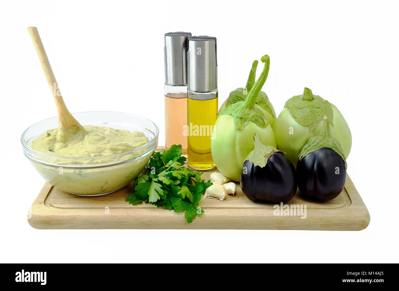 Ready eggplant puree salad in glass bowl and the ingredients used to be made Stock Photo