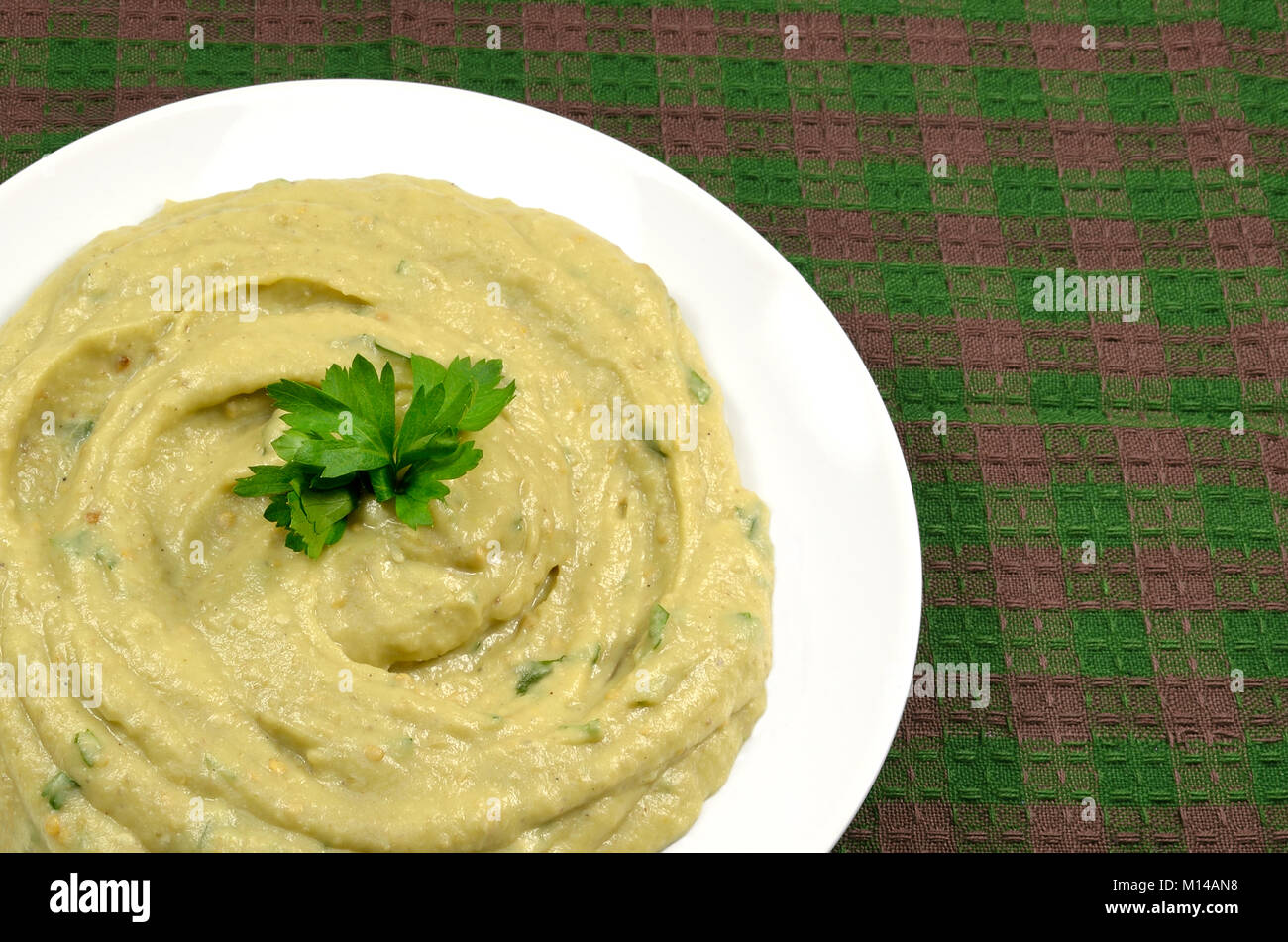 Eggplant puree salad on green and purple tablecloth Stock Photo